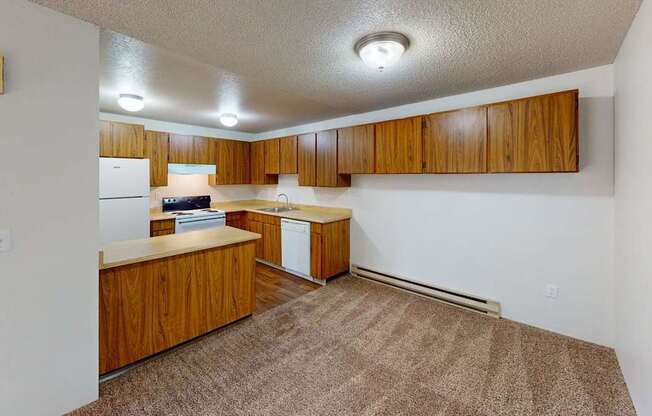 Spacious kitchen area at Heritage Grove Apartments Renton WA featuring timber-style cabinets, ample counter space, and overhead lighting.