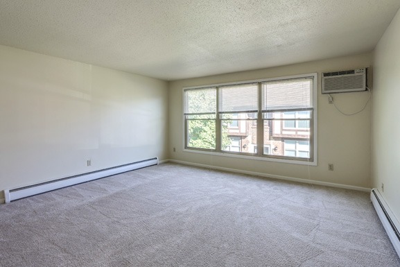 the living room of an empty apartment with a large window