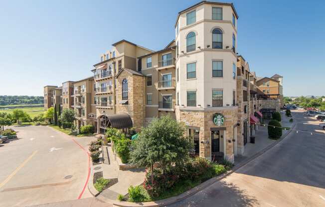 a large apartment building with a street in front of it
