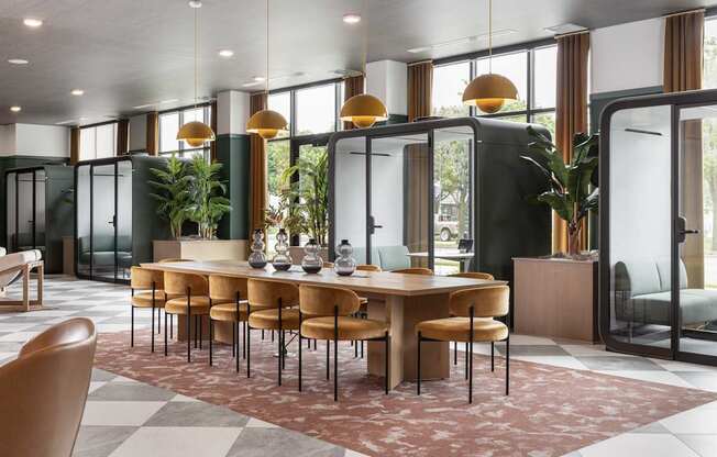 A modern dining room with a large table and chairs.