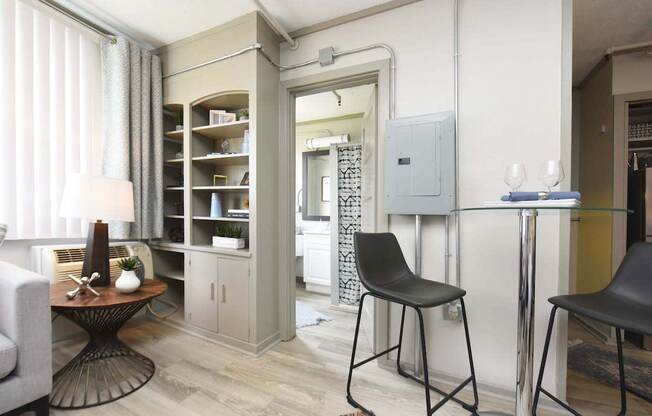 small dining area, built-in shelving, and bathroom entrance