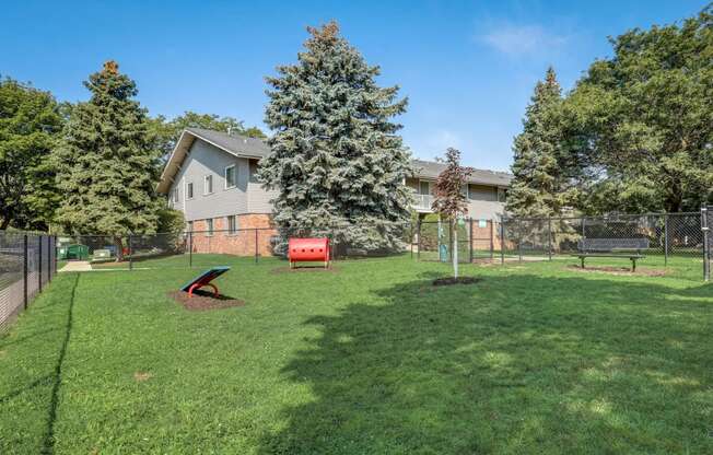 the backyard of a house with a dog park and a fence