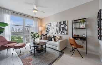 a living room with a white couch and a large window