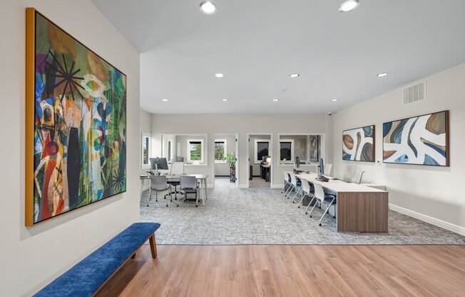 a conference room with a table and chairs and a painting