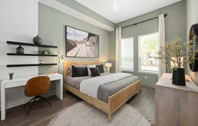 an image of a bedroom with a bed and a desk