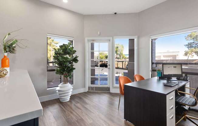 A modern office with a desk, chairs, and a computer.