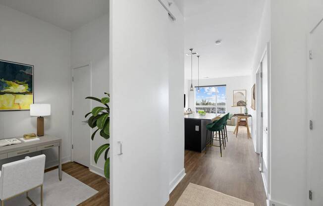 a living room and dining room area with a table and chairs