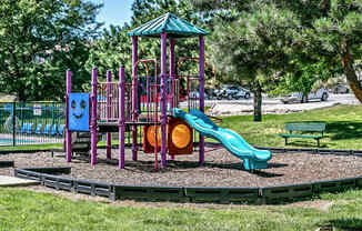 a playground with a slide and other toys in a park
