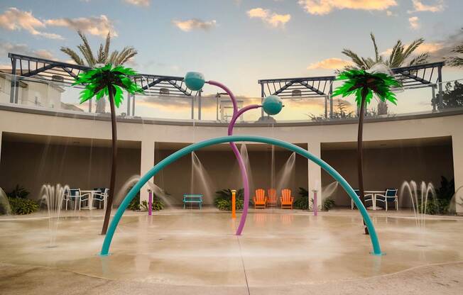 A water fountain with a purple arch and a green palm tree.