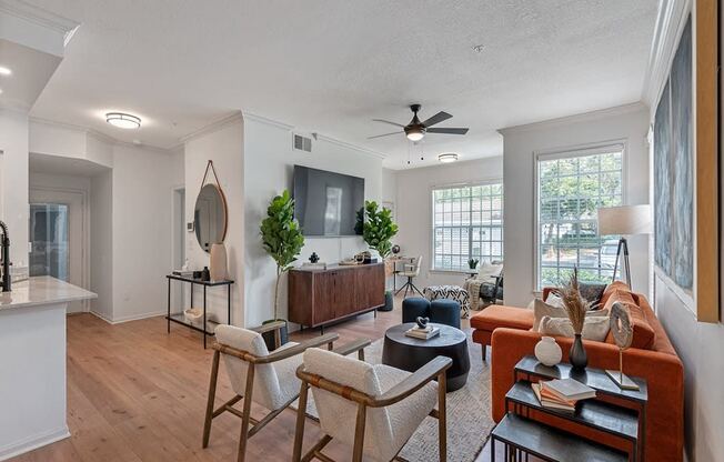 a living room with furniture and a ceiling fan