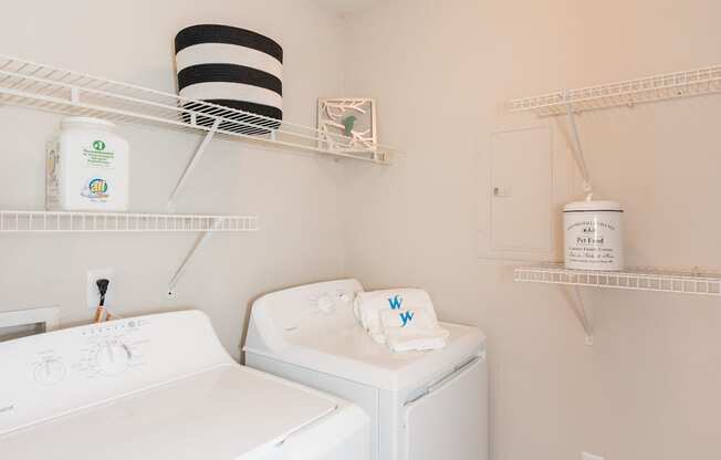 A white washing machine and dryer in a small laundry room.