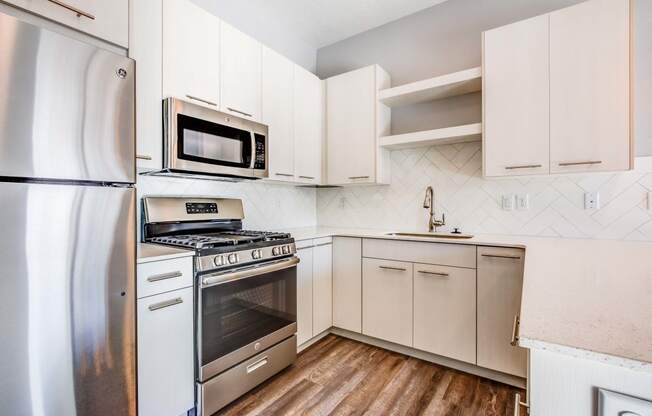 Kitchen with stainless steel appliances and white cabinets