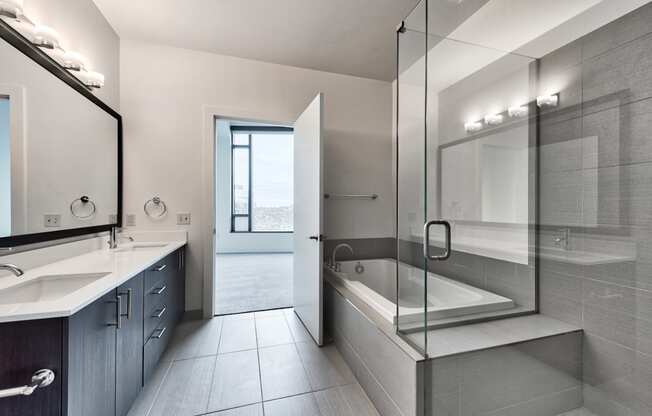 Spa inspired bathroom with glass shower, soaking tub and dual vanity at Cirrus, Seattle, Washington.