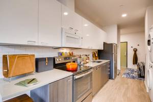a kitchen with a stove top oven next to a refrigerator at Holm at Sellwood, Oregon
