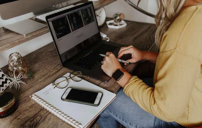 A woman using her laptop as she is working from home.