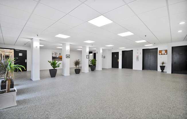 A spacious office lobby with a grey floor and white walls.