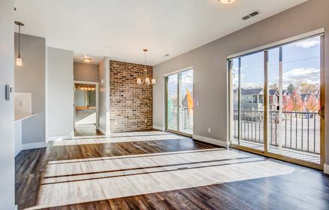 Open living room with exposed brick wall and windows