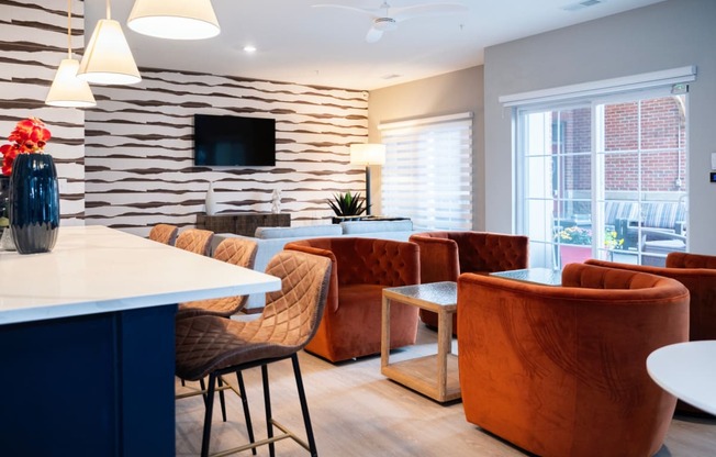 a living room with chairs and a table and a tv