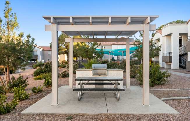 a pergola with a bench and a pool in the background