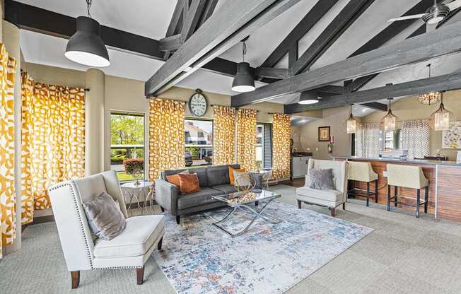 A living room with a grey sofa and a white armchair.
