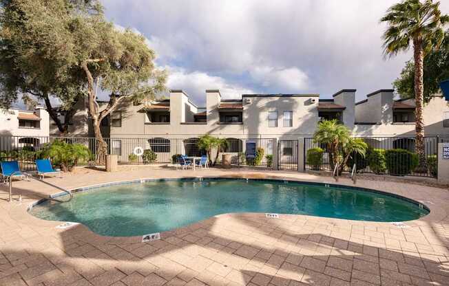 a swimming pool with a house in the background