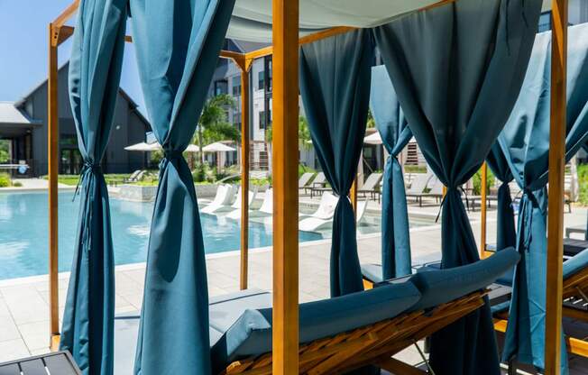 A poolside area with sunshades and loungers.