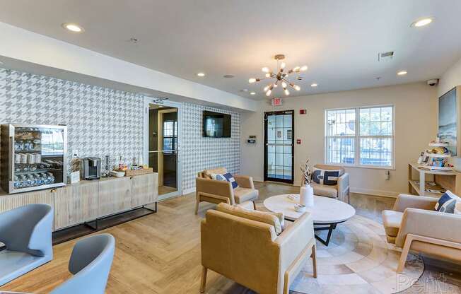 A modern living room with a patterned wallpaper and a variety of seating options.