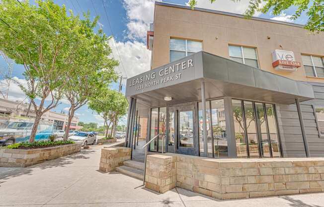 Leasing center entrance with stone base and signage at Vue Live Oak Apartments, Dallas, Texas