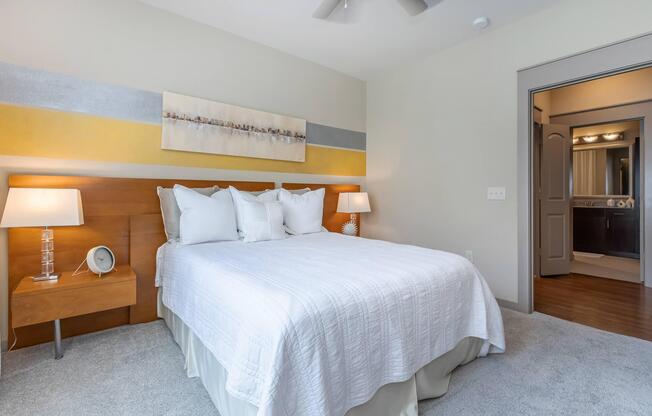 a bedroom with a bed and desk in a hotel room