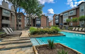 a house with a pool in front of a brick building