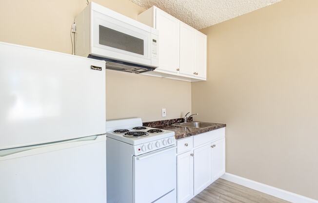 a kitchen with a stove microwave and refrigerator