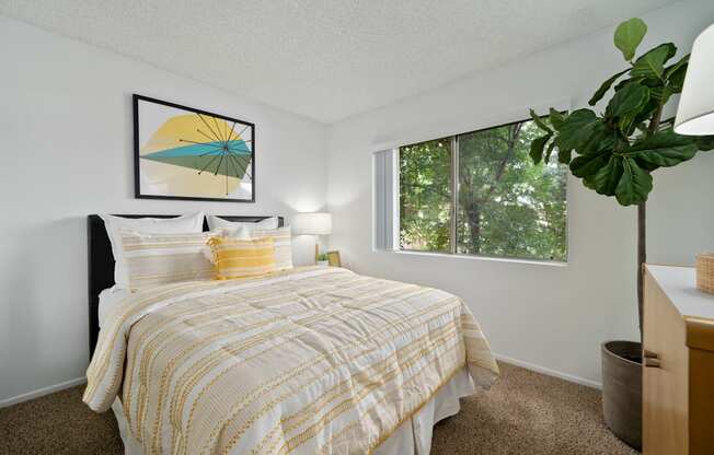 a bedroom with a bed and a large window