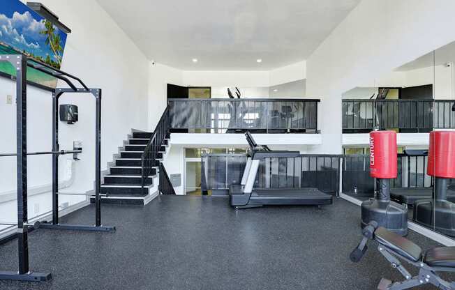 A gym with a variety of equipment including a leg press machine.