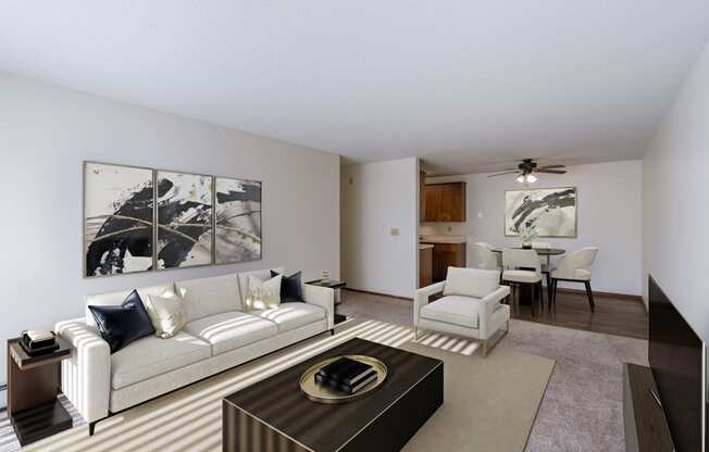 a living room with a couch and a coffee table and a dining room. Fargo, ND Windsor Apartments