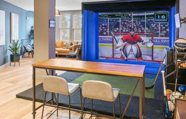 a dining room with a table and chairs and a large screen tv