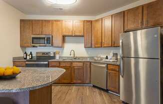 a kitchen with stainless steel appliances and granite counter tops