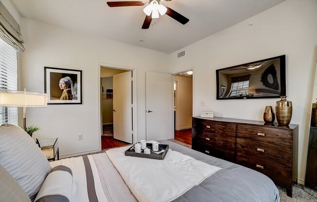 a bedroom with a large bed and a ceiling fan