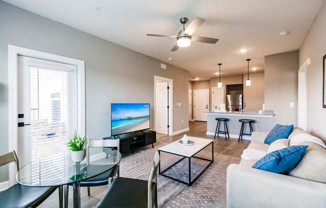 a living room with a couch and a glass table
