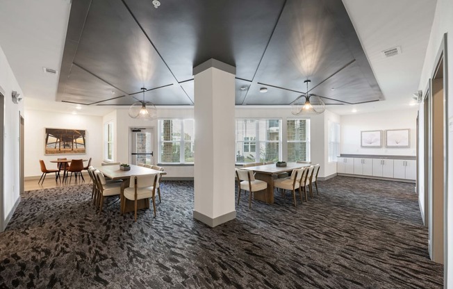 A room with a table and chairs and a ceiling fan.