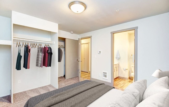 a bedroom with a closet and a bed and a mirror