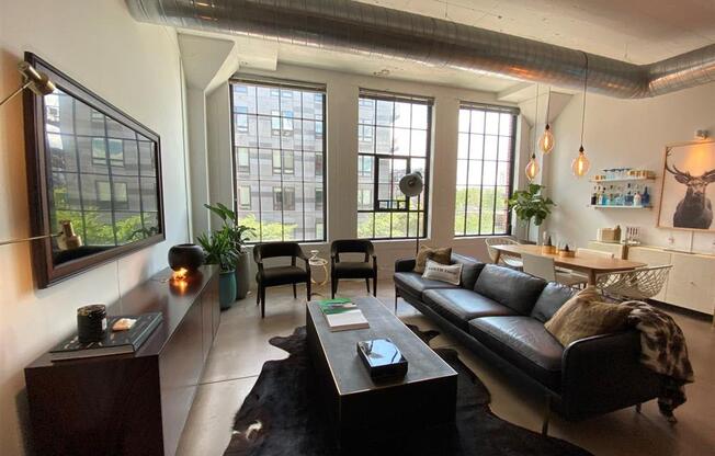living room with tall ceilings and warehouse type windows