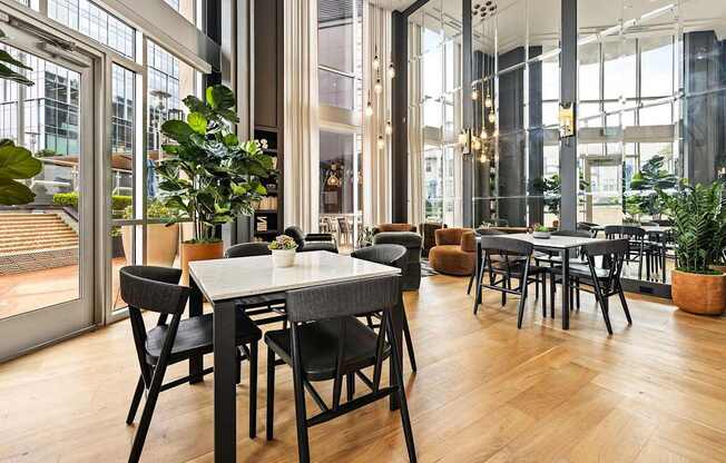 A dining room with a table surrounded by chairs.