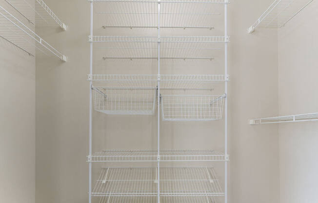 A walk-in closet with wardrobe organizers at Colonial Pointe at Fairview Apartments, Bellevue, 68123