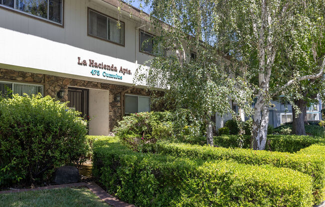 an apartment building with a sign on the front of it