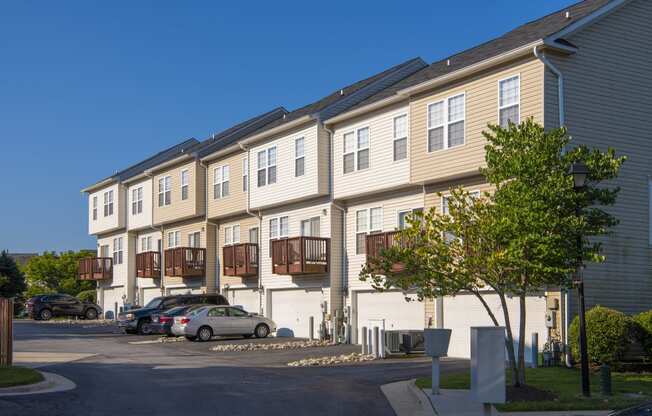 an apartment building with cars parked in front of it