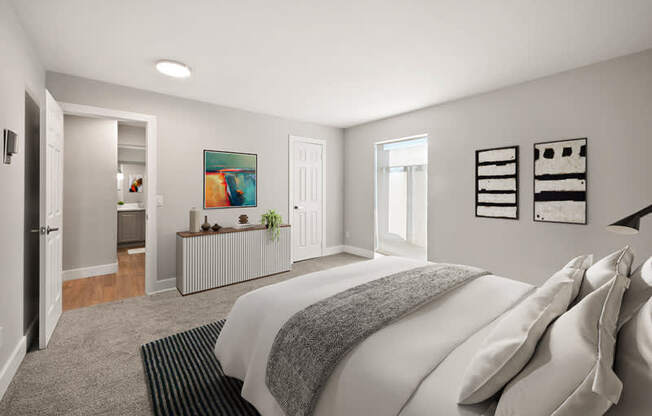 A bedroom with a large bed and a painting on the wall.