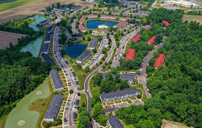 A drone view of an apartment complex with ponds at South Bridge Apartments, Fort Wayne, IN, 46816
