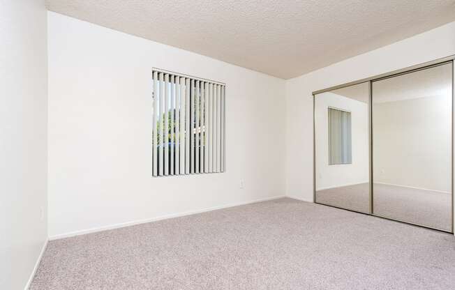 Bedroom with window and closet at Woodbend, Alta Loma