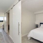 Cozy Bedroom with Sliding Barn Style Doors at Arabella Apartment Homes, Shoreline, WA