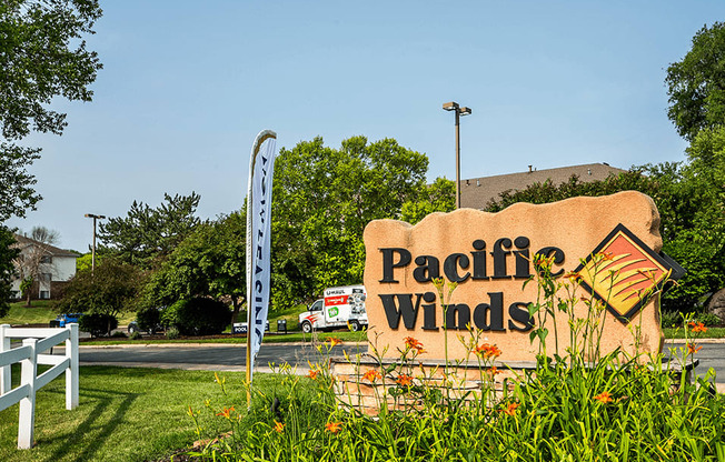 a sign that says pacific winds in front of a building